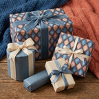 Elegant blue and pink argyle wrapping paper on gift boxes with luxury velvet ribbons by Wrapped Studios.