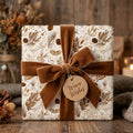 Rustic Christmas wrapping paper with botanical pinecone print and brown velvet bow by Wrapped Studios.
