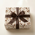 Rustic woodland Christmas wrapping paper with pinecones and a brown bow by Wrapped Studios.