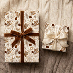 Rustic Christmas wrapping paper with botanical pinecone pattern and velvet bows by Wrapped Studios.