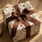 Rustic botanical Christmas wrapping paper with a brown ribbon bow by Wrapped Studios.
