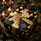 Elegant Christmas gift wrapped in Wrapped Studios tree print paper with gold ribbon and Merry & Bright tag.