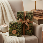 Two presents wrapped in pine needle Christmas gift wrap with brown and green ribbon.