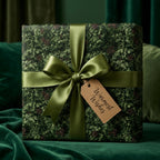 Evergreen pine Christmas wrapping paper with luxury green satin ribbon and tag by Wrapped Studios.