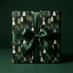Luxury Christmas gift wrap with a green pine tree pattern and satin bow by Wrapped Studios.