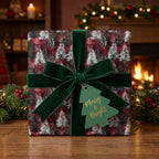 Luxury Christmas wrapping paper with red pine forest pattern and green velvet bow by Wrapped Studios.