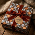 Luxury vintage wrapping paper with a blue and brown plaid design and rust velvet bow, from Wrapped Studios.