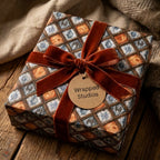 Luxury vintage wrapping paper with a blue and brown plaid design and rust velvet bow, from Wrapped Studios.