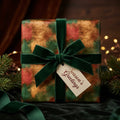 Luxury green and gold Christmas wrapping paper with a velvet ribbon by Wrapped Studios.