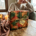 Rustic green and gold luxury gift wrap by Wrapped Studios on a holiday gift box tied with twine.