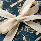 Vintage navy graduation gift wrap with mortarboard pattern and cream cotton bow by Wrapped Studios.