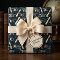 Navy blue graduation wrapping paper with a cream bow and congratulations tag by Wrapped Studios.