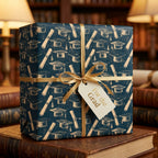 Graduation wrapping paper in navy and gold with ribbon and tag on library books by Wrapped Studios.