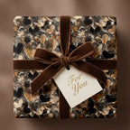 Heart patterned wrapping paper with velvet ribbon by Wrapped Studios.