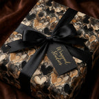 Wrapped Studios heart patterned gift wrap with a black ribbon and tag.
