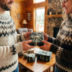 Couple exchanging a holiday gift wrapped in rustic pine tree Christmas wrapping paper by Wrapped Studios.