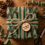 Rustic pine tree Christmas wrapping paper with green ribbon and twine bow, by Wrapped Studios.