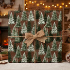 Rustic Christmas wrapping paper with watercolor pine trees and a burlap bow by Wrapped Studios.