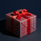 Red and blue plaid Christmas gift wrap with a red satin bow on a box by Wrapped Studios.