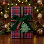 Red plaid Christmas wrapping paper with a green velvet ribbon in a festive holiday setting by Wrapped Studios.