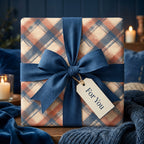 Rustic navy and rust plaid wrapping paper with a blue bow and gift tag by Wrapped Studios.