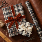 Rustic plaid wrapping paper on holiday gifts with velvet bows by Wrapped Studios.