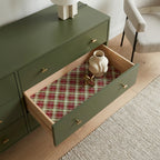 Christmas plaid wrapping paper used as a drawer liner in a green dresser by Wrapped Studios.