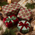 Rustic red and green plaid Christmas wrapping paper with twine bows on holiday gifts by Wrapped Studios.