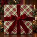 Red and green plaid Christmas wrapping paper with a luxury velvet bow by Wrapped Studios.