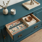 Desert cactus wrapping paper used as a drawer liner in a teal cabinet. By Wrapped Studios.