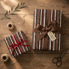 Rustic striped Christmas wrapping paper on gifts with ribbons, by Wrapped Studios.