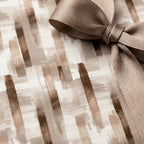 Elegant neutral abstract watercolor wrapping paper with a matching taupe ribbon by Wrapped Studios.