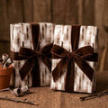 Rustic neutral wrapping paper with brown velvet bows on gifts by Wrapped Studios.