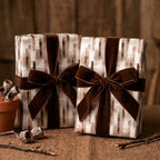 Rustic neutral wrapping paper with brown velvet bows on gifts by Wrapped Studios.