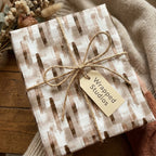 Neutral abstract watercolor wrapping paper by Wrapped Studios, tied with a rustic twine bow.