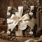 Gothic floral wrapping paper with skulls and a cream satin bow on a gift box by Wrapped Studios.