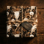 Rustic bull skull and floral wrapping paper by Wrapped Studios on a gift tied with twine.
