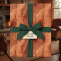 Rustic woodgrain wrapping paper with a green ribbon bow, perfect for nature-themed gifts.
