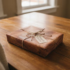 Rustic gift wrap with wood grain pattern and twine bow, perfect for a nature-themed present.