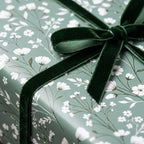 Sage green floral wrapping paper with dark green velvet ribbon, luxury gift wrap by Wrapped Studios.