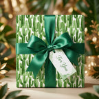 Watercolor cactus wrapping paper with an emerald green ribbon and gift tag by Wrapped Studios.