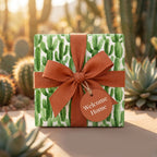 Cactus housewarming wrapping paper with terracotta bow and Welcome Home tag by Wrapped Studios.
