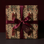Wrapped Studios elegant Christmas gift wrap. Features vintage Santa Claus pattern and a burgundy satin bow.