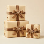 Elegant tan gift boxes wrapped in solid wrapping paper with soft brown velvet ribbon bows for birthdays or special occasions.