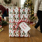 Funny frog Christmas wrapping paper by Wrapped Studios on a holiday gift tied with red string and a Ribbit tag.