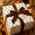 Jazz saxophone wrapping paper with a brown velvet ribbon and birthday tag by Wrapped Studios.