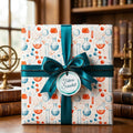 Science wrapping paper with chemistry beakers, a teal bow, and a Future Scientist tag by Wrapped Studios.