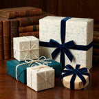 Vintage math wrapping paper with navy velvet ribbon on gift boxes by Wrapped Studios.