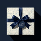 Math wrapping paper with blue science equations, navy satin bow, and gift tag by Wrapped Studios.