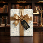 Graduation wrapping paper with math formulas and a gold bow by Wrapped Studios.